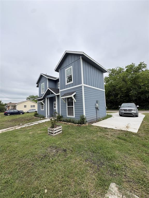 Contemporary two-story residence featuring light blue horizontal siding and vertical board and batten accents