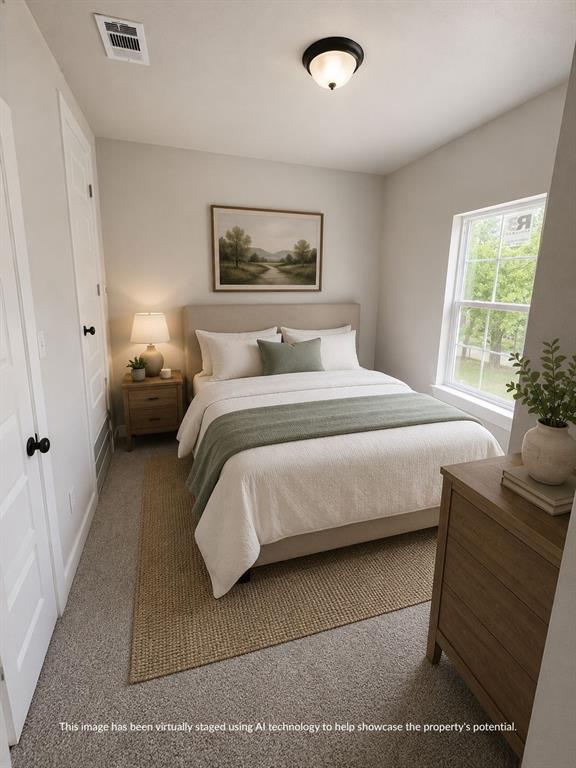 Neutral-toned bedroom featuring a double-hung window, light gray carpeting, and a flush-mount ceiling light fixture