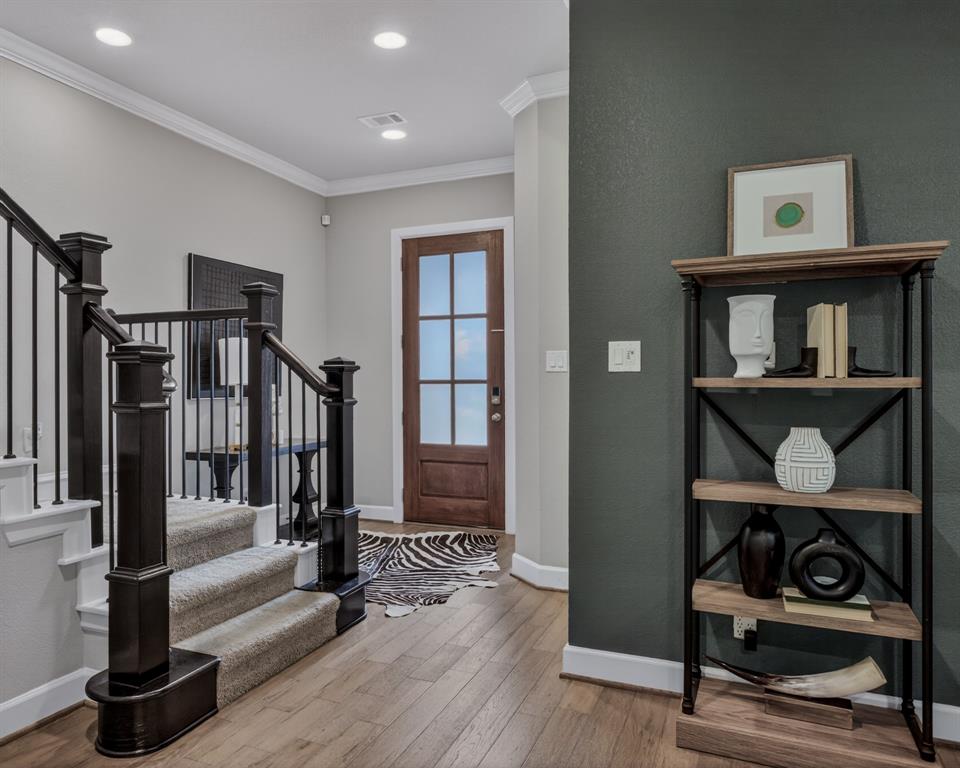 Inviting and well appointed entryway showcasing hardwood floors throughout.