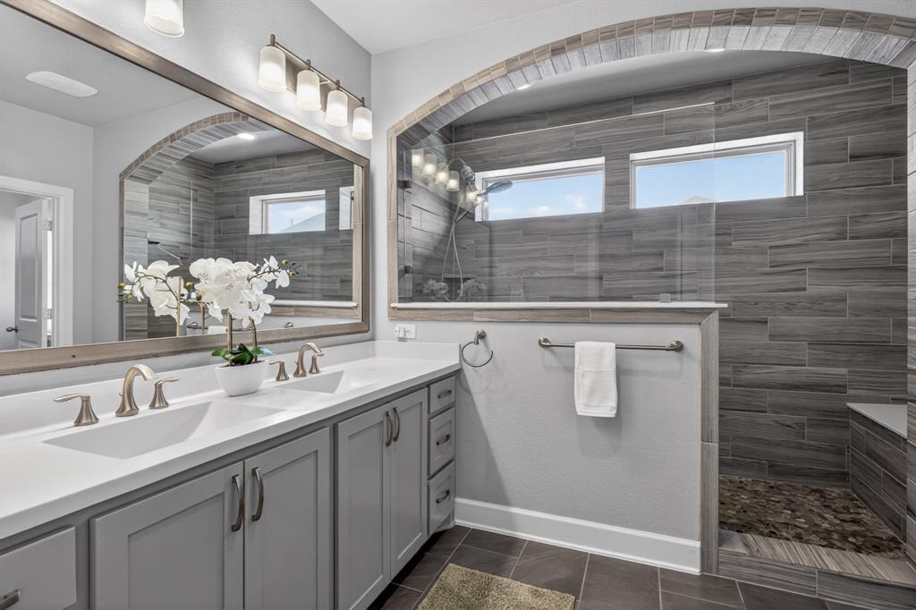 Spacious primary bath featuring a large walk-in shower and a relaxing, spa-like atmosphere.
