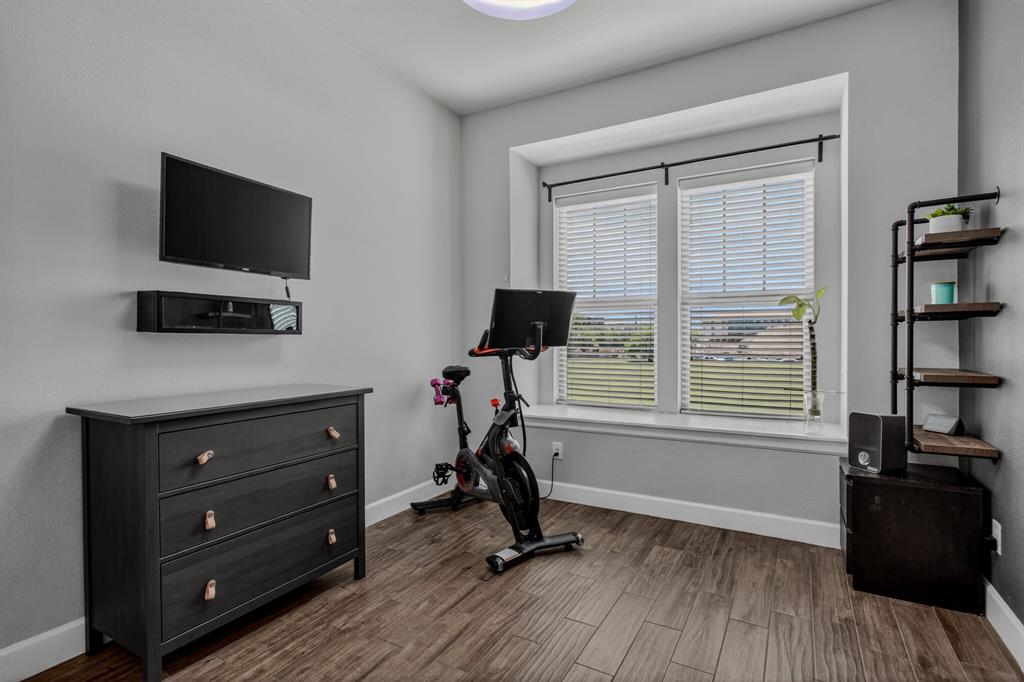 Secondary bedroom currently used as a workout room.
