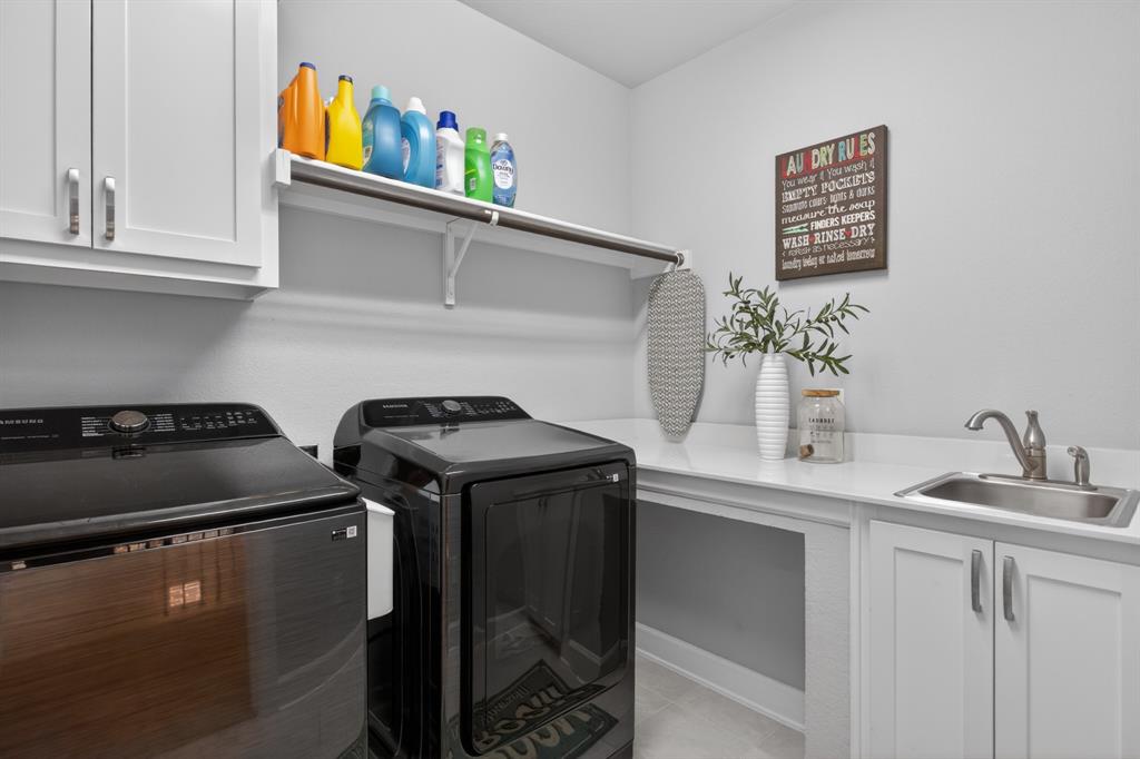 Functional laundry area with ample storage space to keep everything organized and convenient.