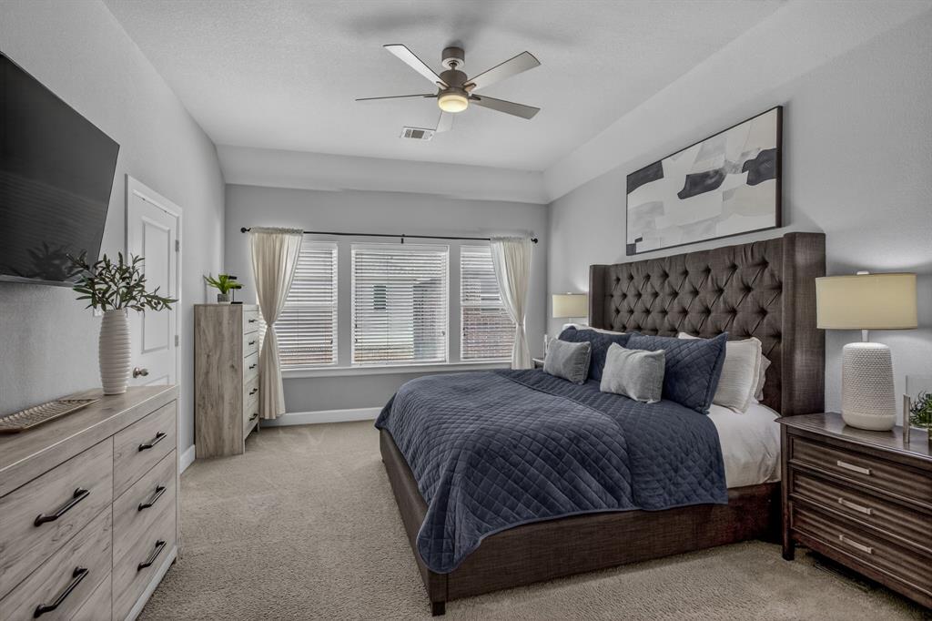 Spacious primary bedroom filled with natural light.