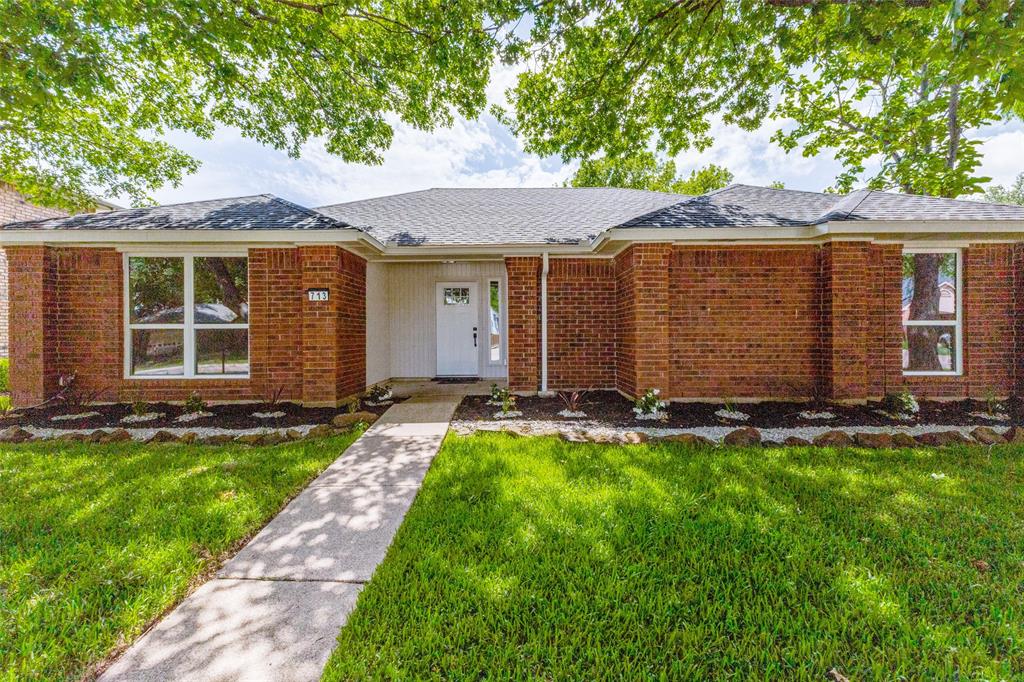 Brick facade with white trim and a contrasting dark roof Brick facade with white trim and a contrasting dark roof