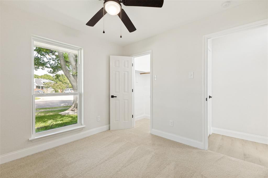 Bedroom featuring neutral-toned carpet flooring and a double-hung window