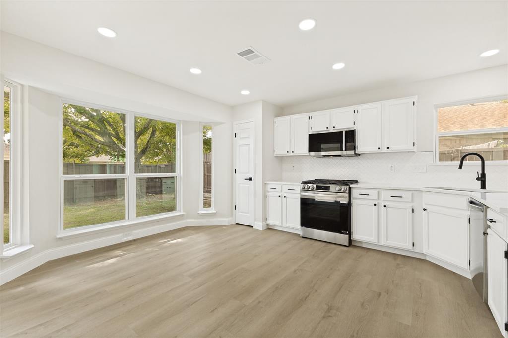 Kitchen and dining area featuring light wood-finish flooring