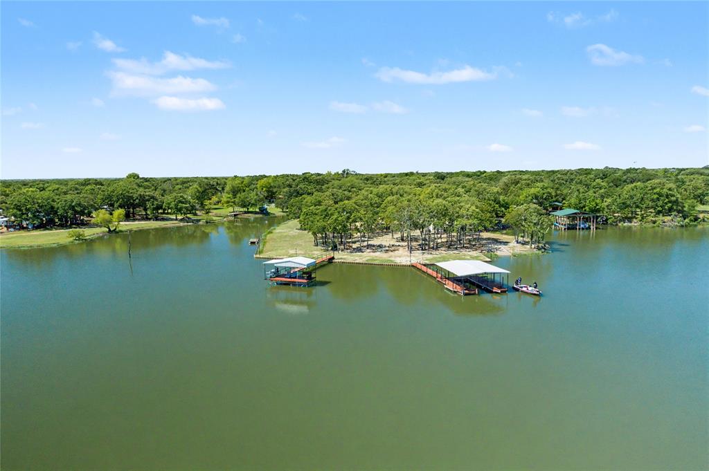 Expansive lakefront property featuring multiple boat docks with covered slips