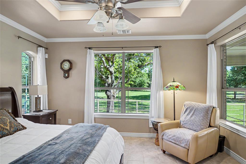 Room with a tray ceiling and a ceiling fan light fixture