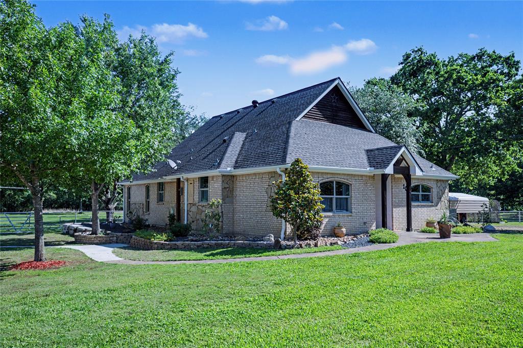 Brick exterior with gabled roofline and dark shingle roofing