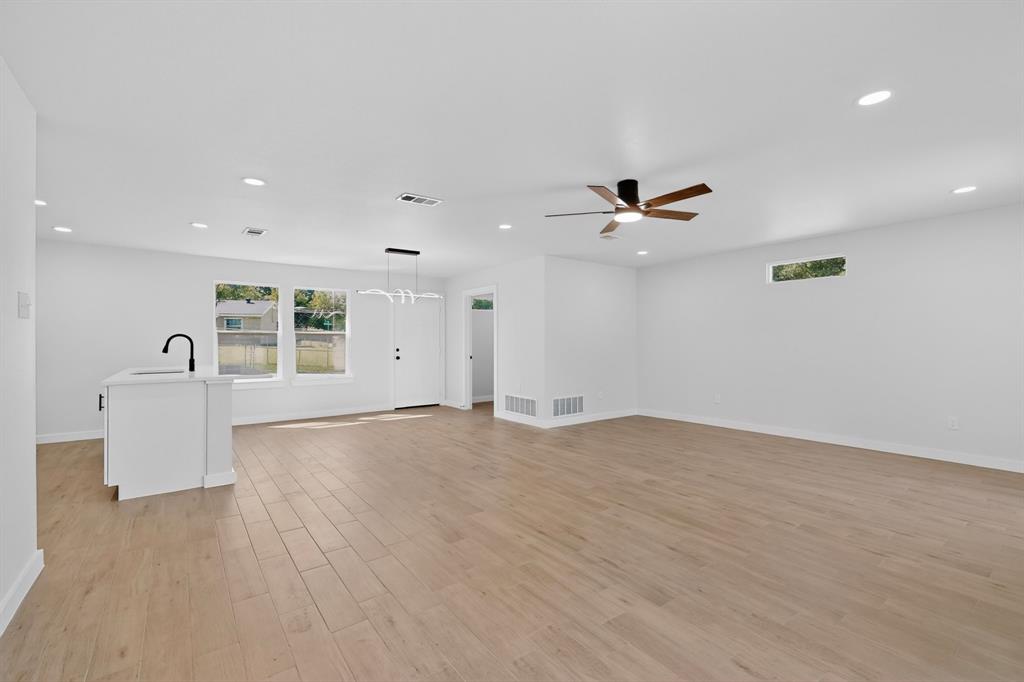 Open-concept interior featuring wood-finish flooring, recessed lighting, and a modern ceiling fan