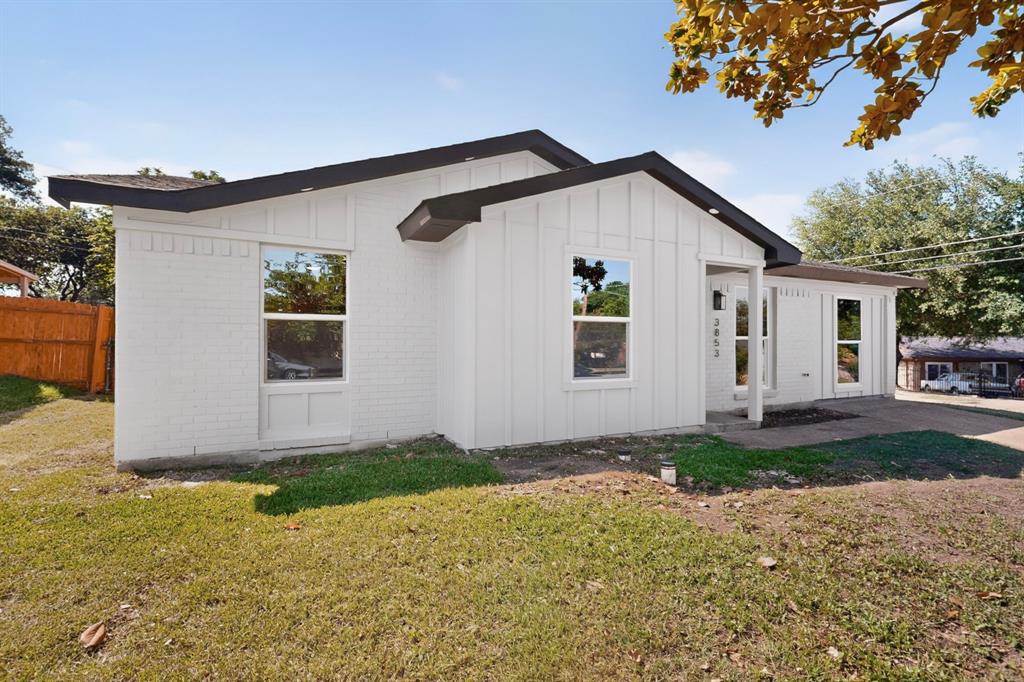 Crisp white exterior featuring board and batten siding and painted brick