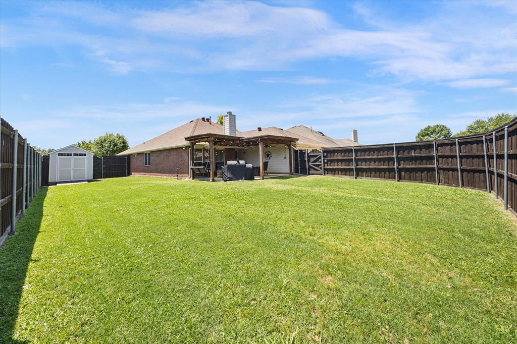 The backyard has plenty of space for a pool, playset, dog run or all three!
