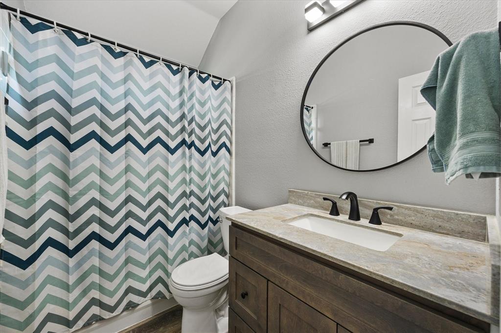 The hall bath has been updated with a granite-topped vanity, mirror, lighting, fixtures and hardware.