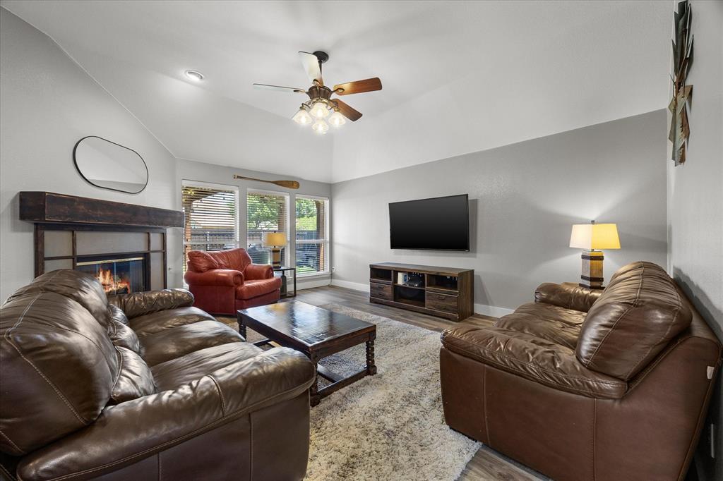 The warm and inviting family room features a gas-log fireplace with custom surround and mantle.