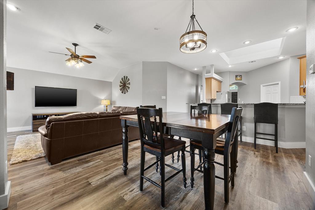 Trendy lighting defines the dining area that has a door leading to the covered patio.