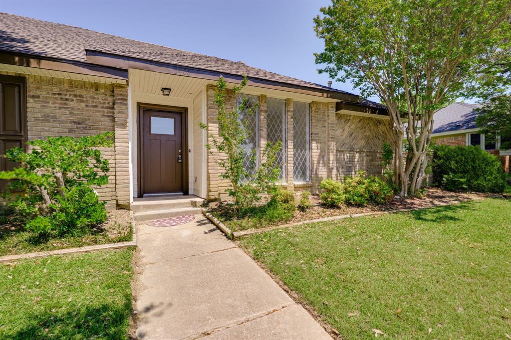 Brick exterior with an entryway featuring a brown door with a window pane Brick exterior with an entryway featuring a brown door with a window pane