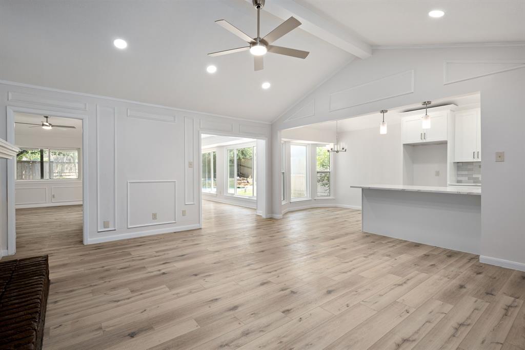 Vaulted ceilings with exposed beams, recessed lighting, and a ceiling fan Vaulted ceilings with exposed beams, recessed lighting, and a ceiling fan