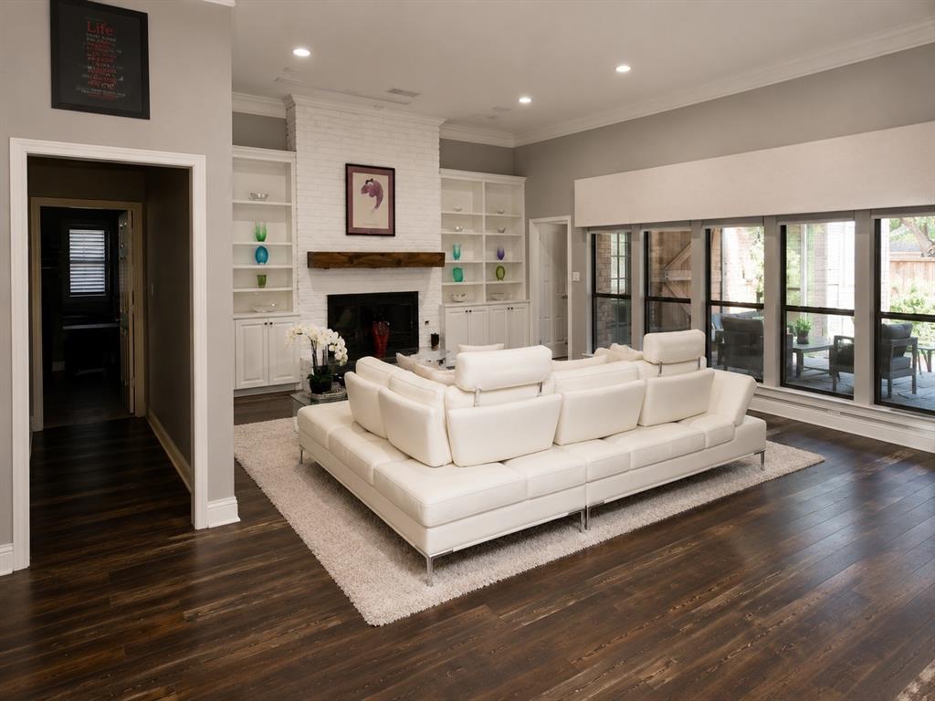 Build-in shelving frames fireplace. Large Windows overlook patio and pool