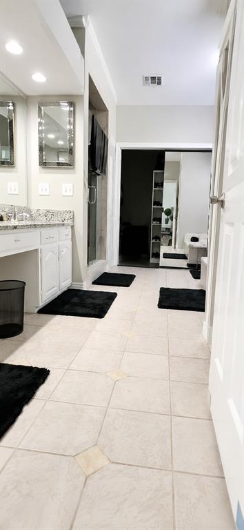 Large bath with custom his and hers closet, abundant storage!