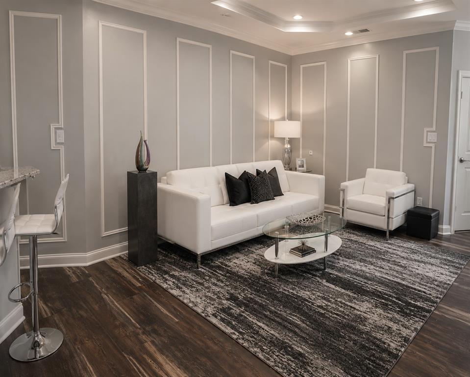 Den with bar opens to pool, kitchen, and breakfast area