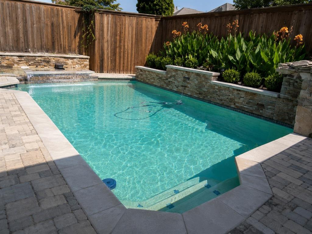 Low maintenance plants surround the pool area.  the fountain makes this a sound and visual paradise!
