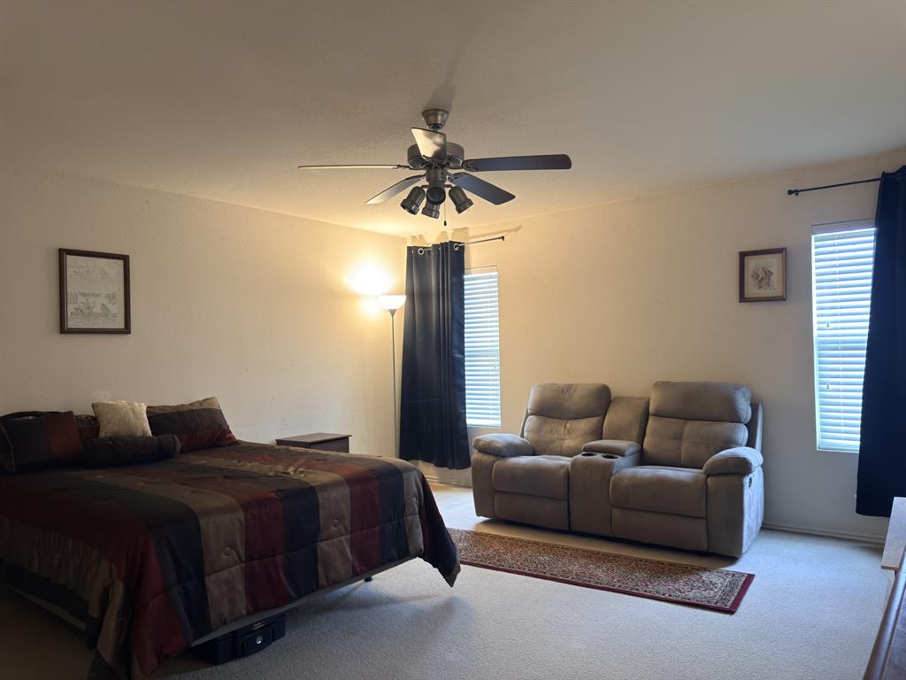 Primary bedroom with sitting area.