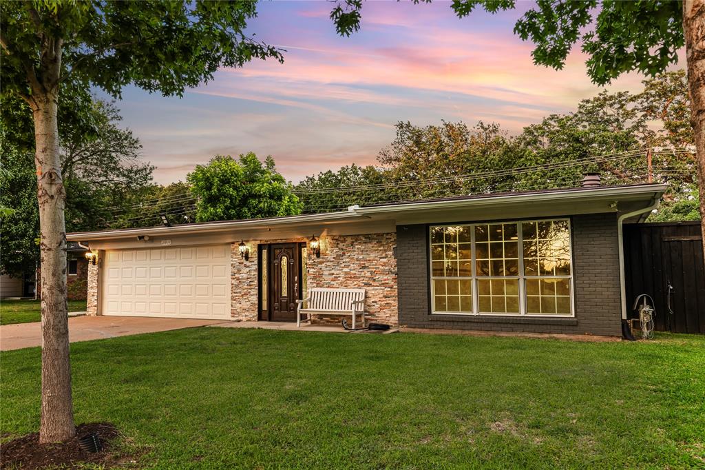 Exterior featuring stone veneer and painted brick facade