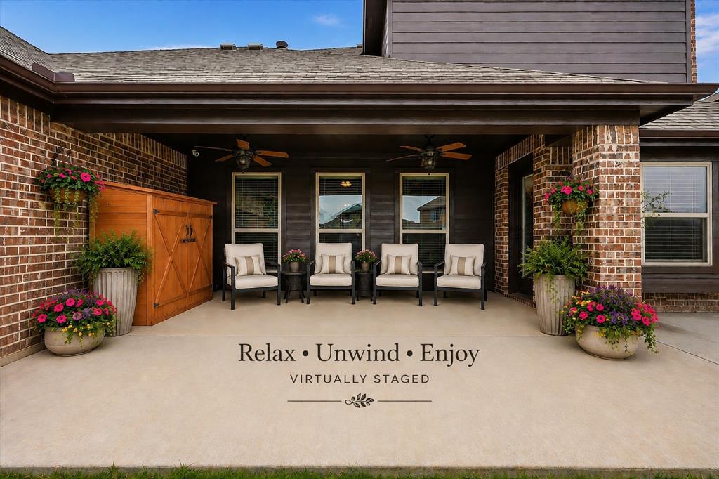 Virtual Staged Covered patio featuring brick and horizontal siding, concrete flooring, and ceiling fans