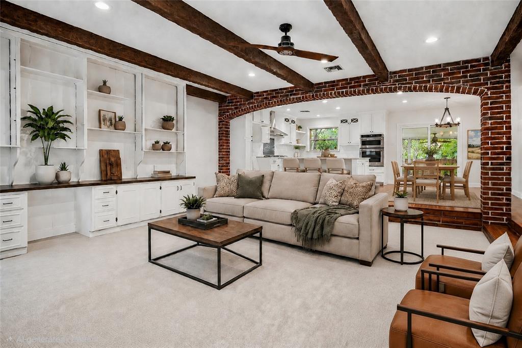 VIRTUAL STAGING Spacious living area featuring exposed wood beams, recessed lighting, and built-in white cabinetry with a wood-finish countertop