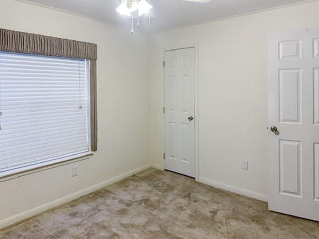 Neutral-toned carpeting and light-colored walls create a versatile interior