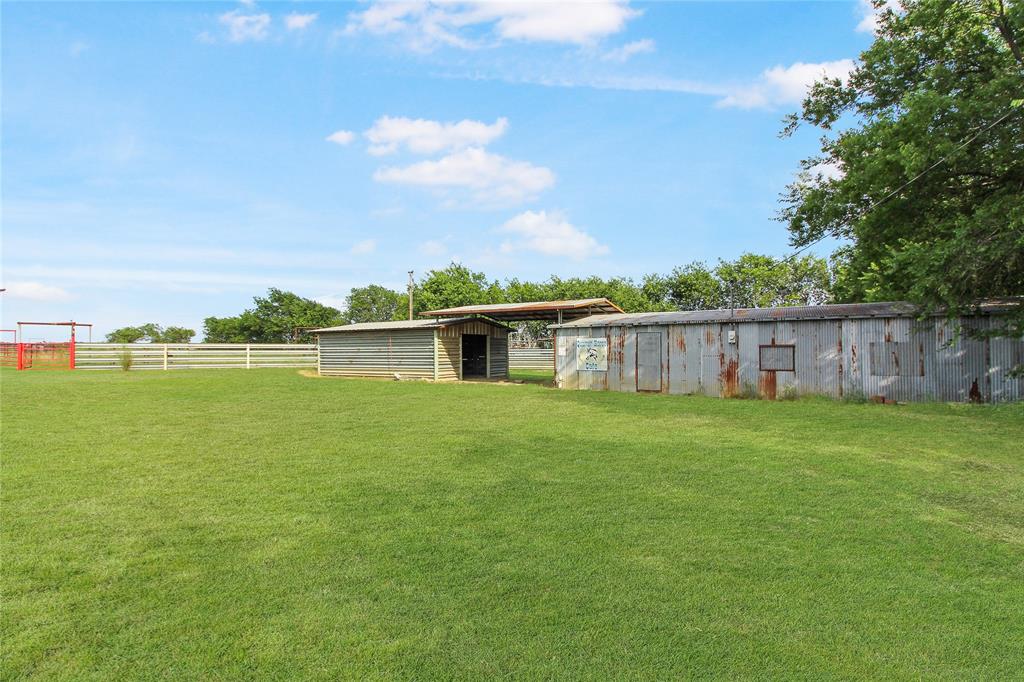 Expansive green lawn with a white perimeter fence