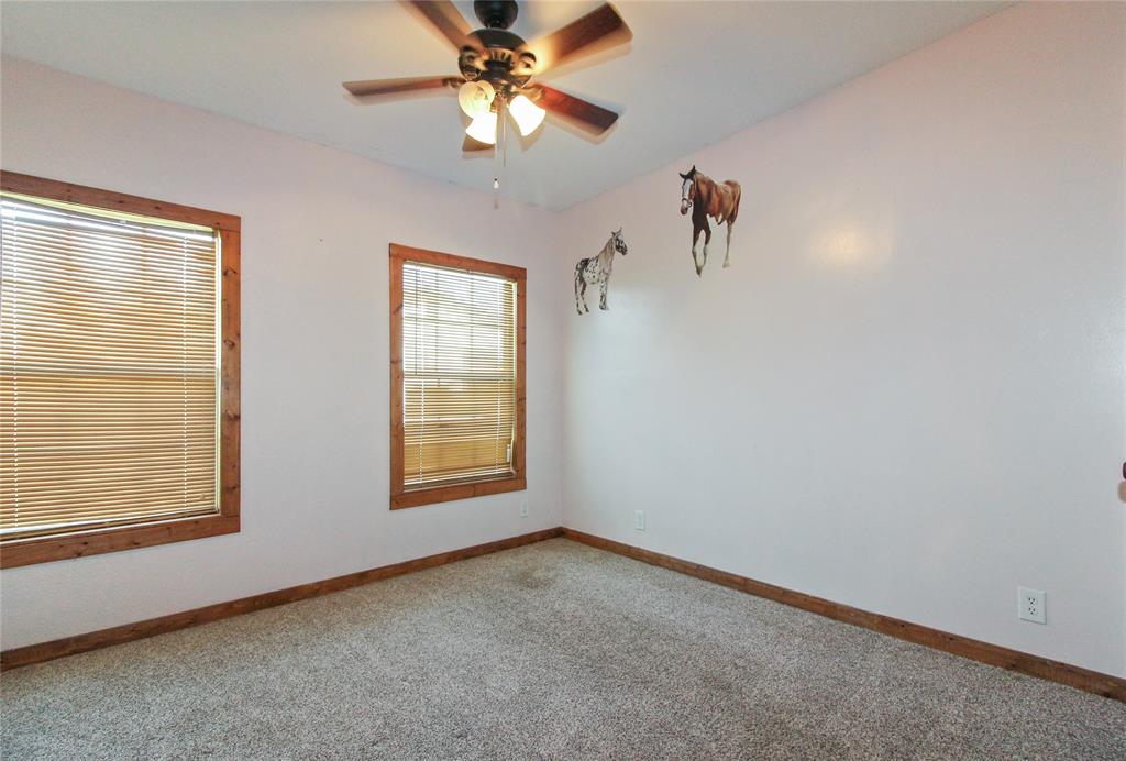 1936  HOUSE Carpeted room featuring dual windows with wood-finish trim and blinds