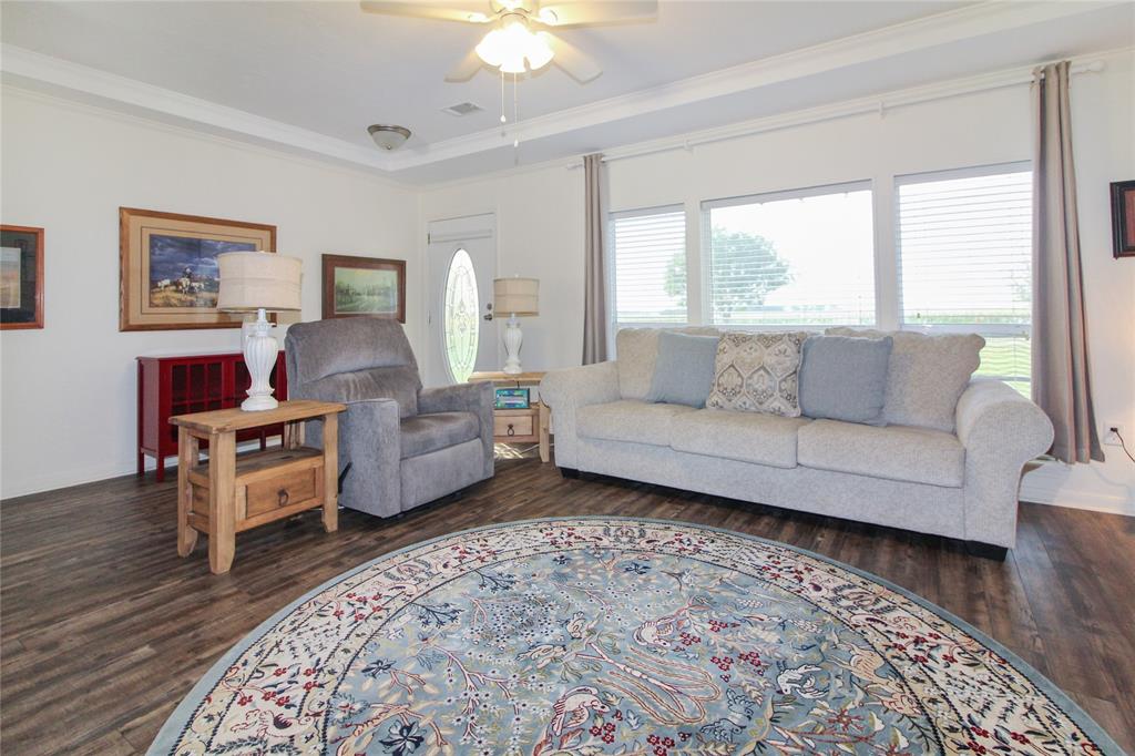 Spacious interior featuring wood-finish flooring, white walls, and crown molding
