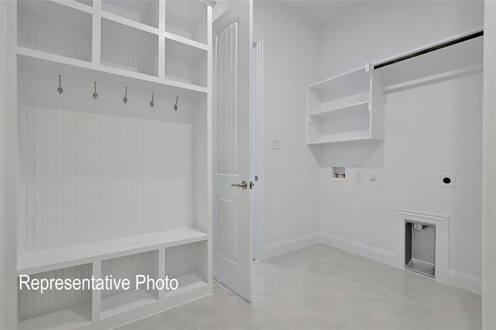 Entryway featuring a built-in mudroom bench with integrated shelving and coat hooks