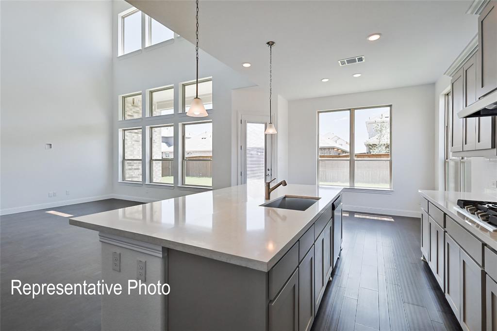 Kitchen island with a light-toned countertop and an undermount sink