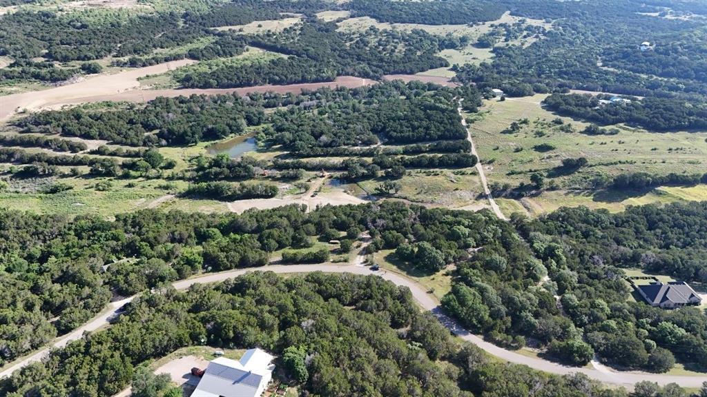 Expansive rural landscape featuring a winding road and verdant tree coverage