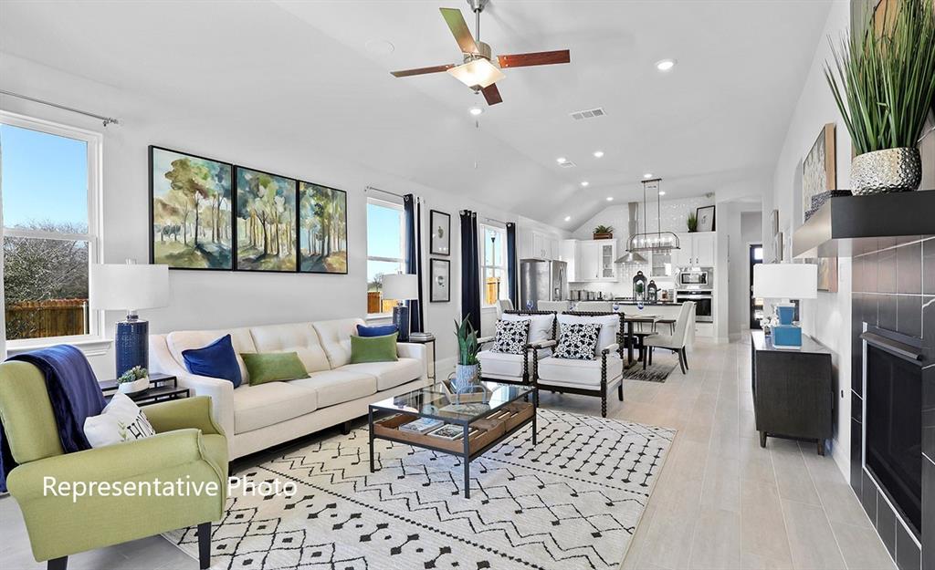 Open-concept living space with vaulted ceilings, wood-finish flooring, and recessed lighting