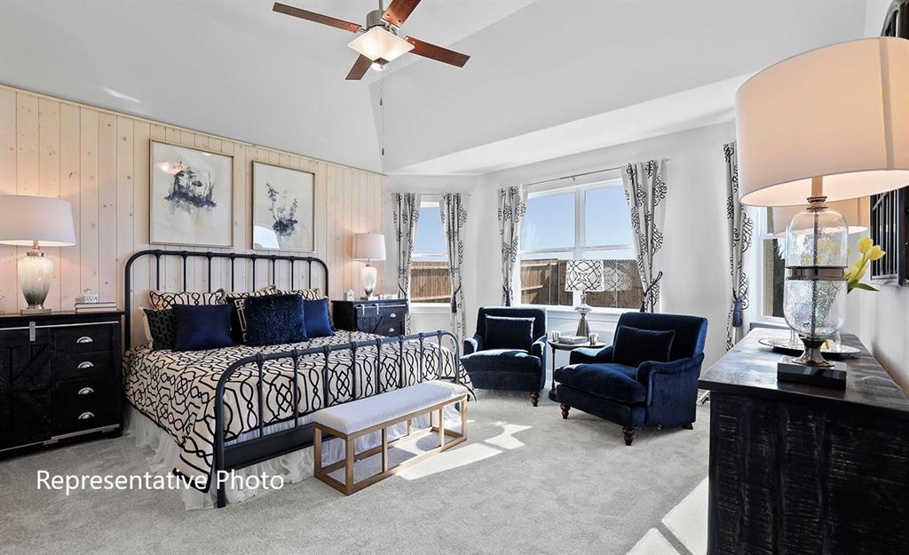 Room featuring vaulted ceilings with a ceiling fan, a shiplap accent wall, and carpet flooring