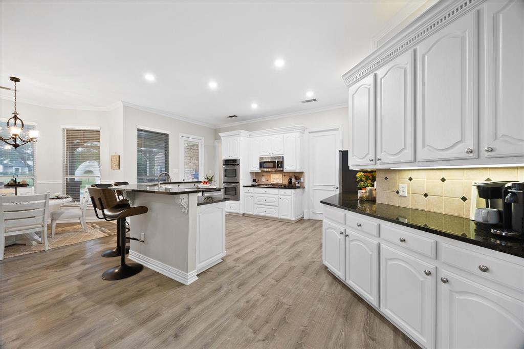 Open floor plan features dream kitchen overlooking breakfast area and family room