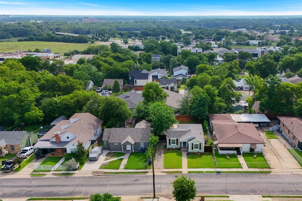 Residential neighborhood featuring a variety of architectural styles, mature trees, and a clear blue sky