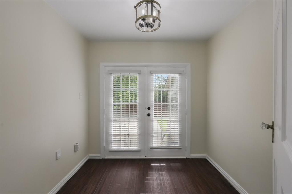 Space ideal for an office, reading or art room.  Light-toned walls, and a ceiling-mounted light fixture