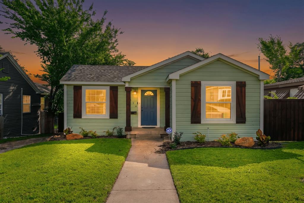 Light green siding exterior with a dark blue entry door, wood shutters, and a covered porch Light green siding exterior with a dark blue entry door, wood shutters, and a covered porch