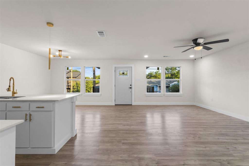 Open concept living area featuring wood-finish flooring