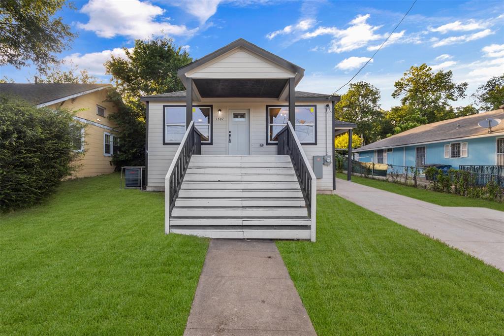 Charming home with a covered front porch and contrasting black trim
