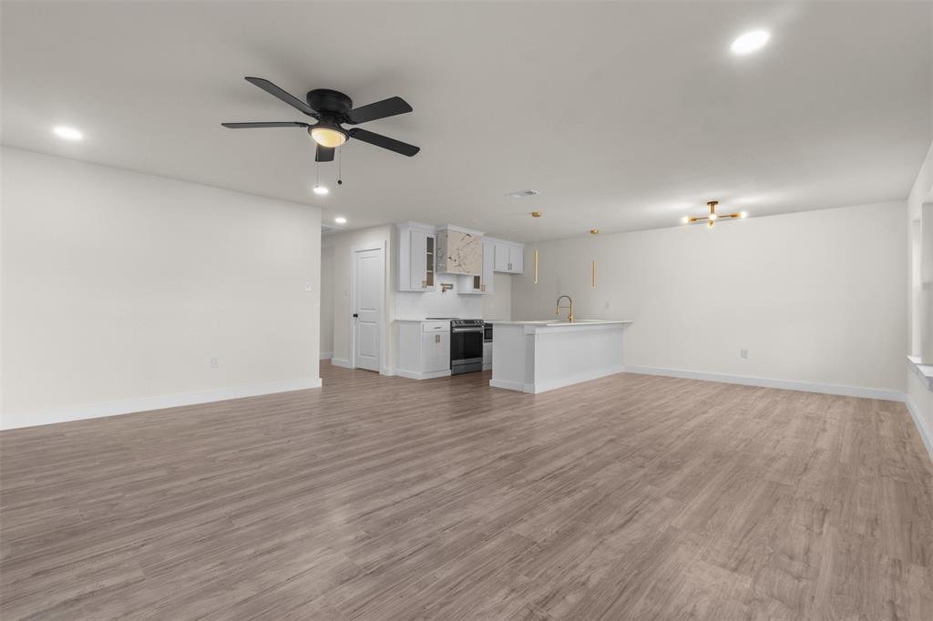Open-concept living space featuring wood-finish flooring, recessed lighting, and a modern ceiling fan
