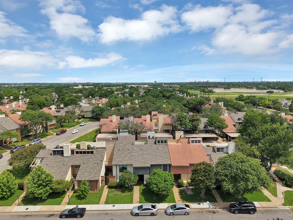 Aerial perspective showcasing a residential neighborhood with varied roofing materials
