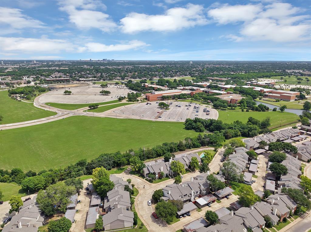 Aerial perspective showcasing a residential community with asphalt shingle roofs