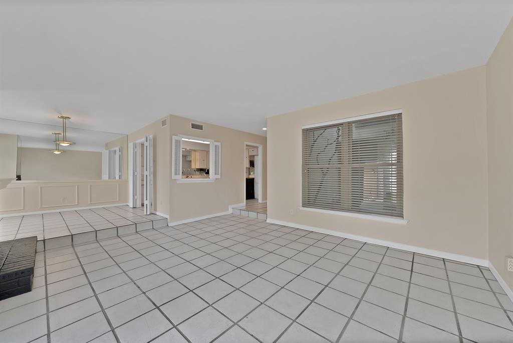 Spacious interior featuring light-toned tile flooring throughout and neutral wall paint