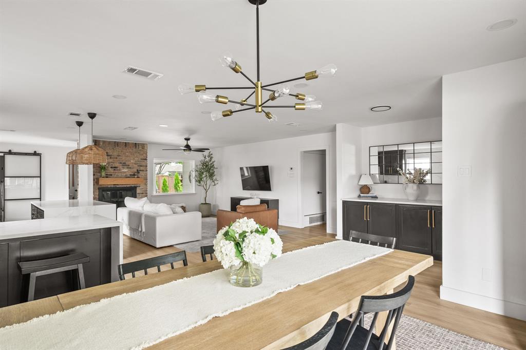Open-concept dining and living areas featuring wood-finish flooring Open-concept dining and living areas featuring wood-finish flooring