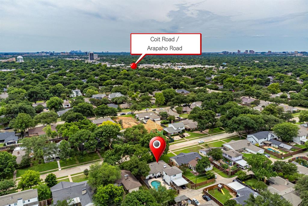 Aerial perspective showcasing a residential area with dense tree canopy